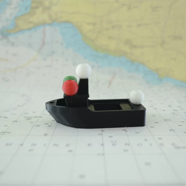 Image of a powered vessel noght shape and navigation lights from a side view
